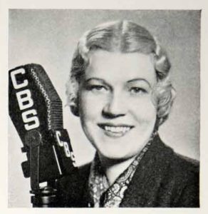 Headshot of Kathryn Cravens, in the nid 1930s, with a CBS microphone